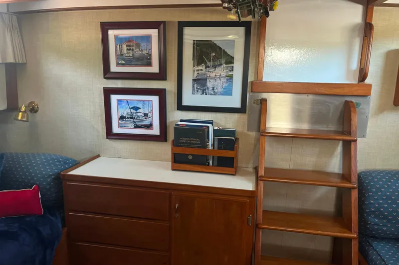 Slide: The Image of Interior of 1972 DeFever 38 Passagemaker with framed art, wooden ladder, and bookshelf. - 55