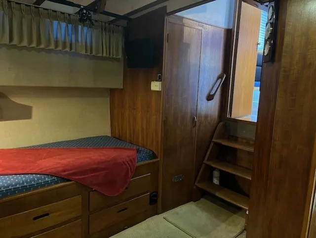 Slide: The Image of Interior of 1972 DeFever 38 Passagemaker with wooden paneling and cozy sleeping area. - 58