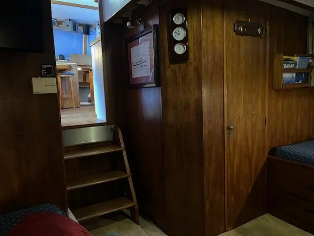 Slide: The Image of Interior of 1972 DeFever 38 Passagemaker with wooden paneling and stairs. - 59
