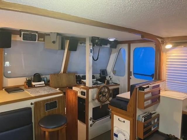 Slide: The Image of Interior of a 1972 DeFever 38 Passagemaker boat, featuring a classic helm and navigation area. - 6