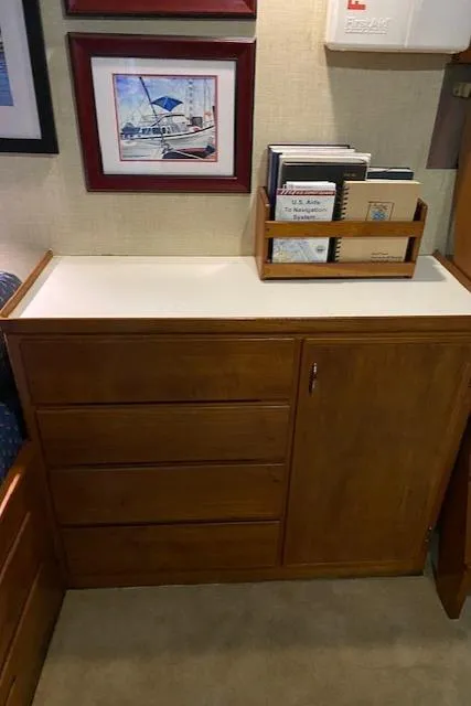 Slide: The Image of Wooden cabinet with drawers and books, inside a 1972 DeFever 38 Passagemaker yacht. - 62