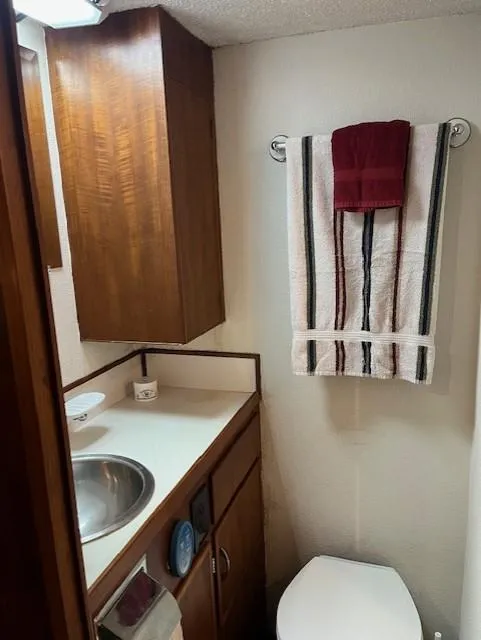Slide: The Image of 1972 DeFever 38 Passagemaker bathroom with wooden cabinets, sink, and towel rack. - 63