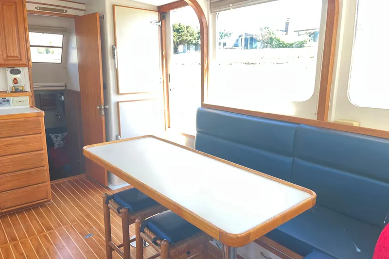 Slide: The Image of Interior of 1972 DeFever 38 Passagemaker with wooden cabinetry and blue seating. - 7