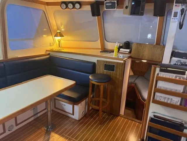 Slide: The Image of Interior of 1972 DeFever 38 Passagemaker with cozy seating and wooden accents. - 8