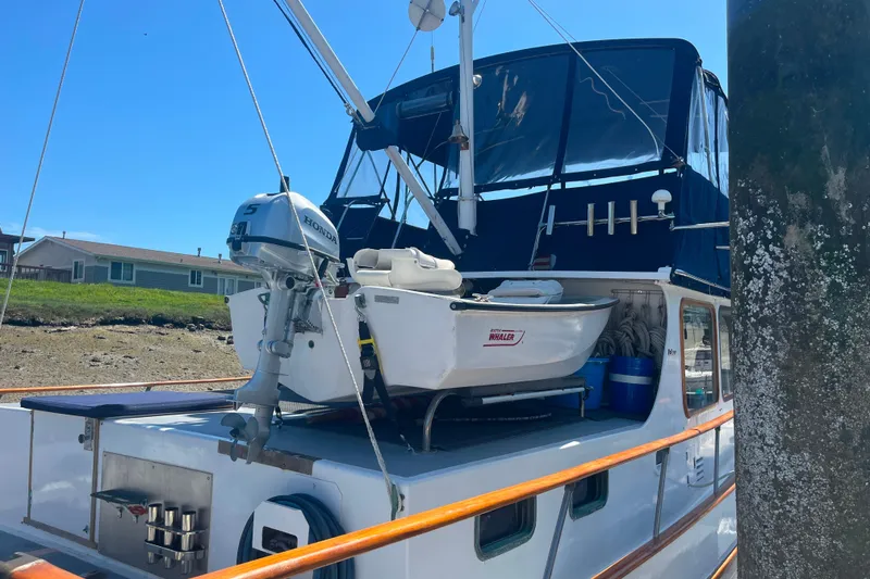 Slide: The Image of 1972 DeFever 38 Passagemaker yacht with a small boat and Honda motor on deck. - 89