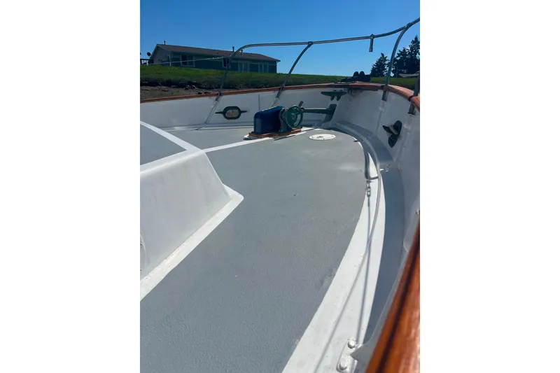 Slide: The Image of 1972 DeFever 38 Passagemaker boat deck with railing and winch under clear blue sky. - 91
