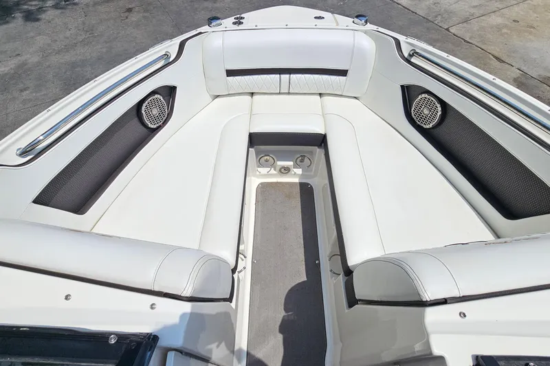 Slide: The Image of 2018 Sea Ray SLX 230 boat interior with white seating and built-in speakers. - 10