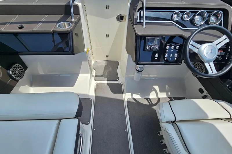 Slide: The Image of 2018 Sea Ray SLX 230 boat interior with modern dashboard and comfortable seating. - 11