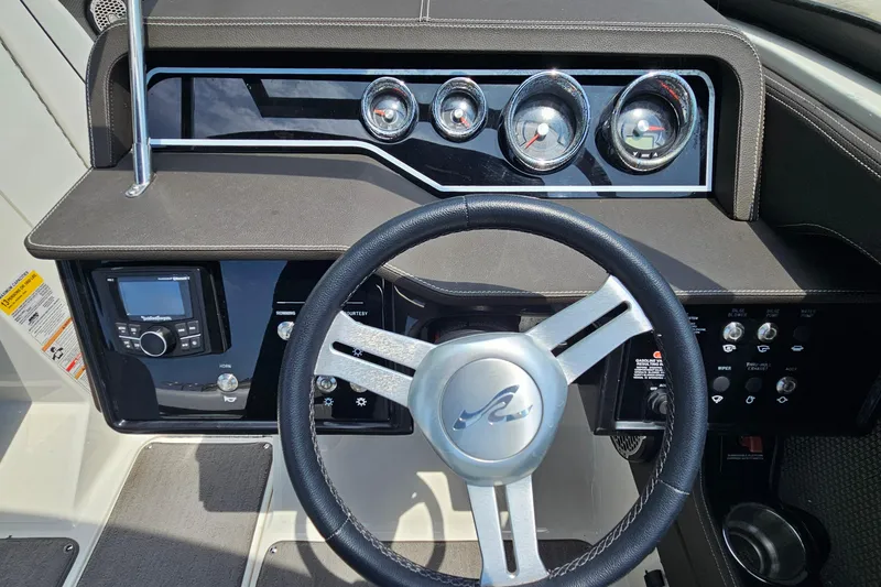 Slide: The Image of 2018 Sea Ray SLX 230 dashboard with steering wheel and instrument panel. - 14
