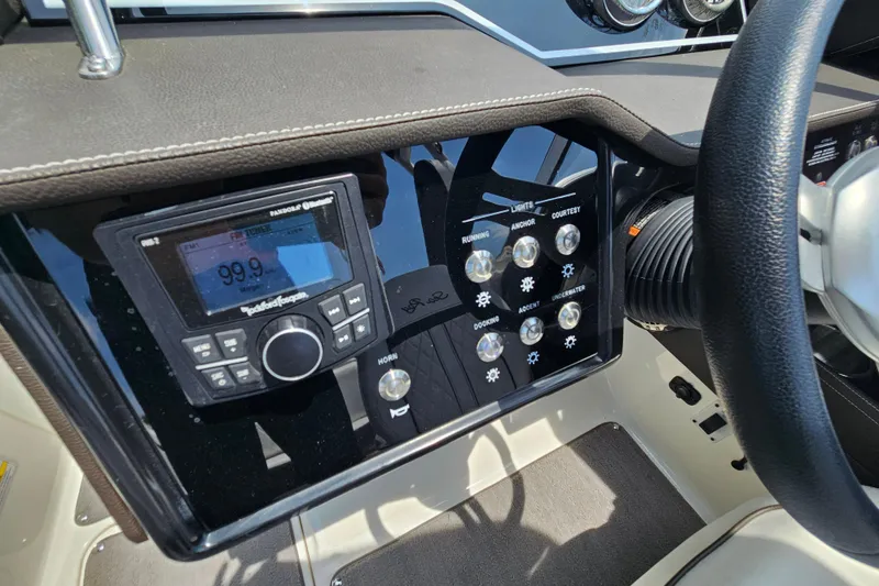 Slide: The Image of 2018 Sea Ray SLX 230 dashboard with radio and control panel. - 15