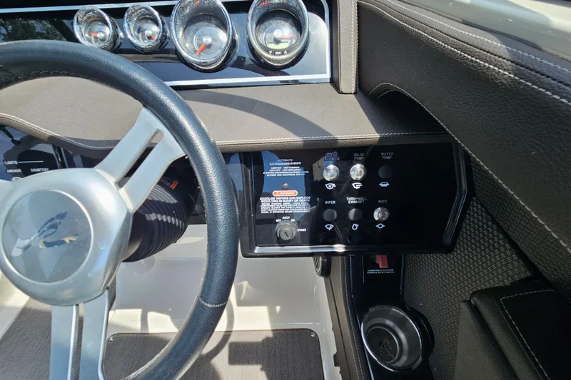 Slide: The Image of Dashboard of a 2018 Sea Ray SLX 230 boat with steering wheel and control panel. - 16