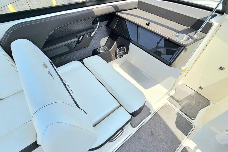 Slide: The Image of Interior of 2018 Sea Ray SLX 230 boat with white seating and cup holder. - 18