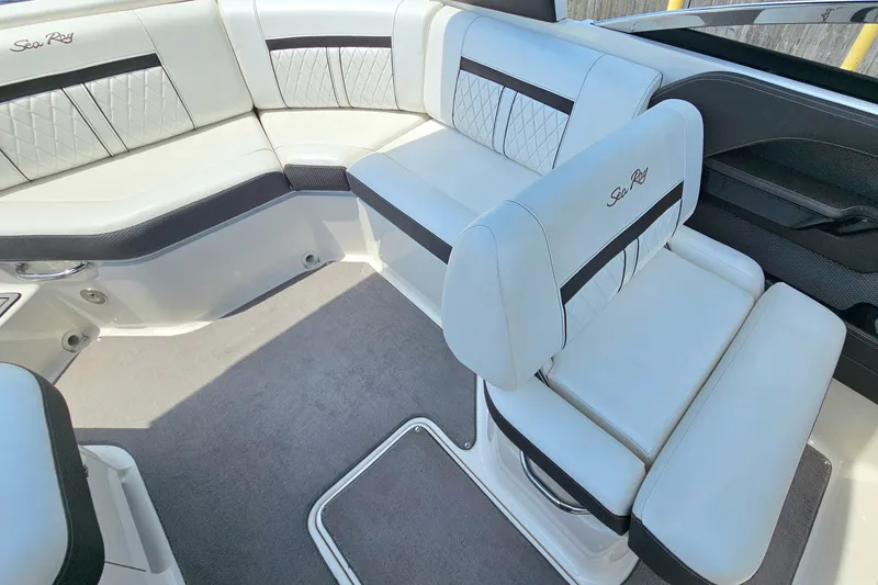Slide: The Image of Luxurious interior seating of 2018 Sea Ray SLX 230 boat with elegant white upholstery. - 19