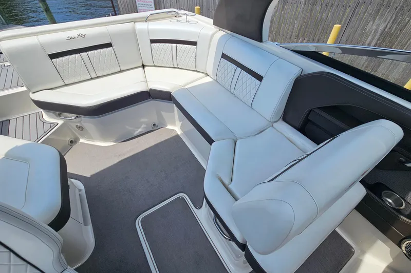Slide: The Image of Interior seating of a 2018 Sea Ray SLX 230 boat, featuring luxurious white upholstery. - 20