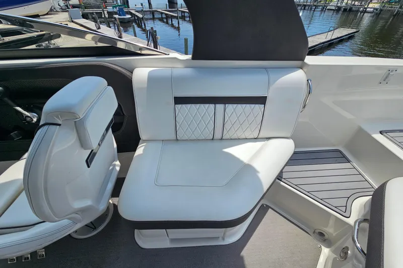 Slide: The Image of Luxurious seating on a 2018 Sea Ray SLX 230 boat, featuring elegant white upholstery. - 21
