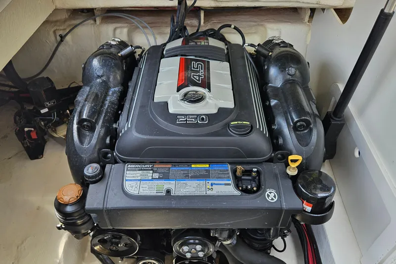 Slide: The Image of Engine compartment of a 2018 Sea Ray SLX 230 boat, featuring a Mercury 4.5L 250 HP engine. - 25