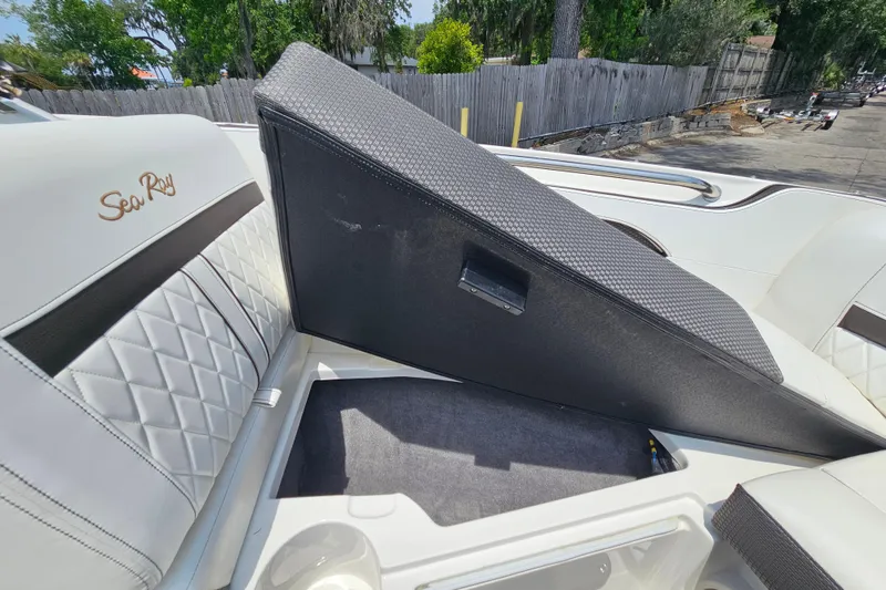 Slide: The Image of 2018 Sea Ray SLX 230 boat with open storage compartment and quilted seating. - 29