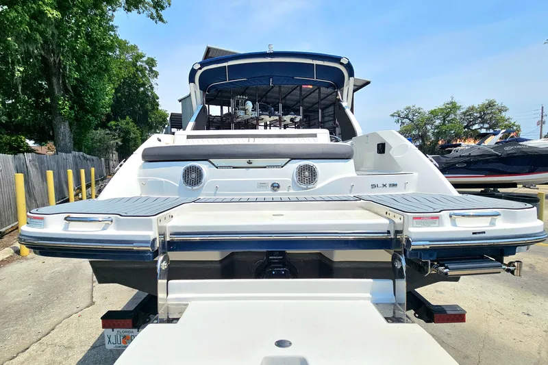 Slide: The Image of 2018 Sea Ray SLX 230 boat rear view with swim platform and seating. - 4