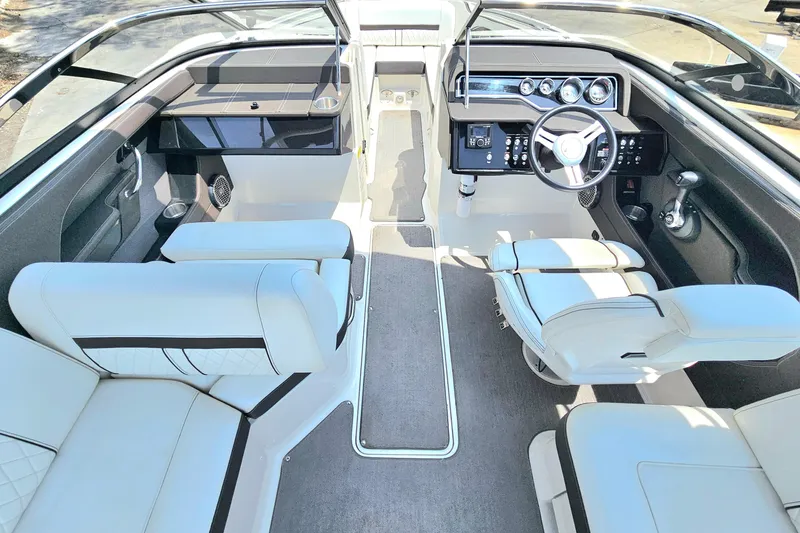 Slide: The Image of Interior of 2018 Sea Ray SLX 230 boat with luxurious seating and modern dashboard. - 9