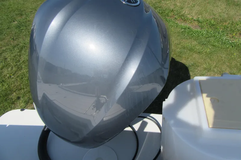 Slide: The Image of Close-up of a 2013 Parker 2320 SL Sport Cabin boat's metallic engine cover. - 10