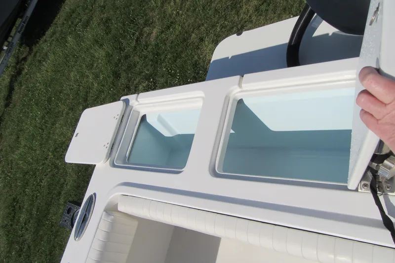 Slide: The Image of 2013 Parker 2320 SL Sport Cabin boat with open storage compartments. - 12