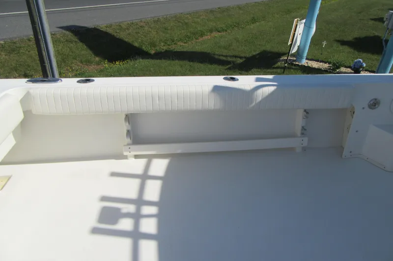 Slide: The Image of 2013 Parker 2320 SL Sport Cabin boat interior with white seating and rod holders. - 15