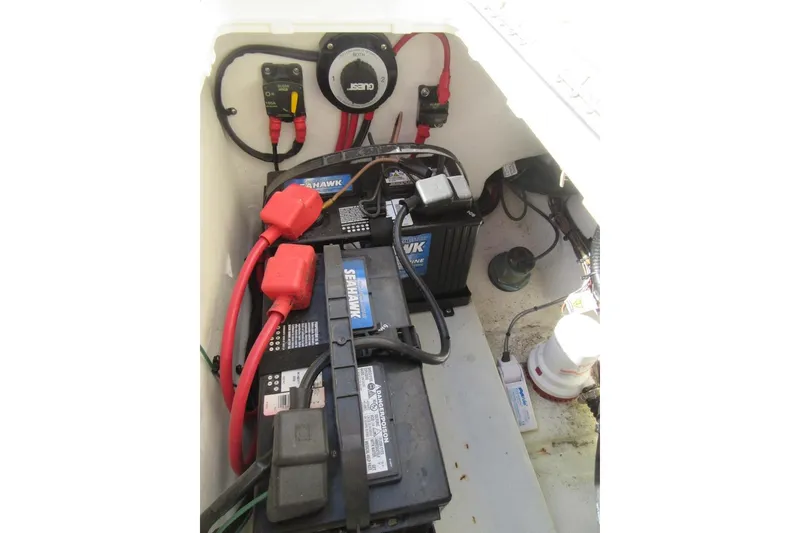Slide: The Image of Battery compartment of a 2013 Parker 2320 SL Sport Cabin boat, featuring wiring and connections. - 21