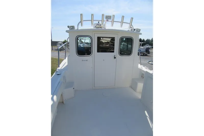 Slide: The Image of 2013 Parker 2320 SL Sport Cabin boat with spacious deck and cabin view. - 24