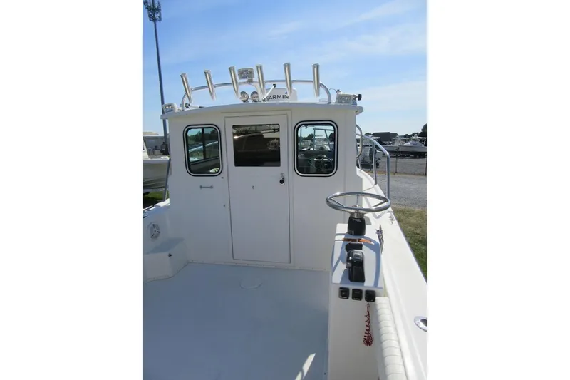Slide: The Image of 2013 Parker 2320 SL Sport Cabin boat, featuring a spacious deck and cabin entry. - 25