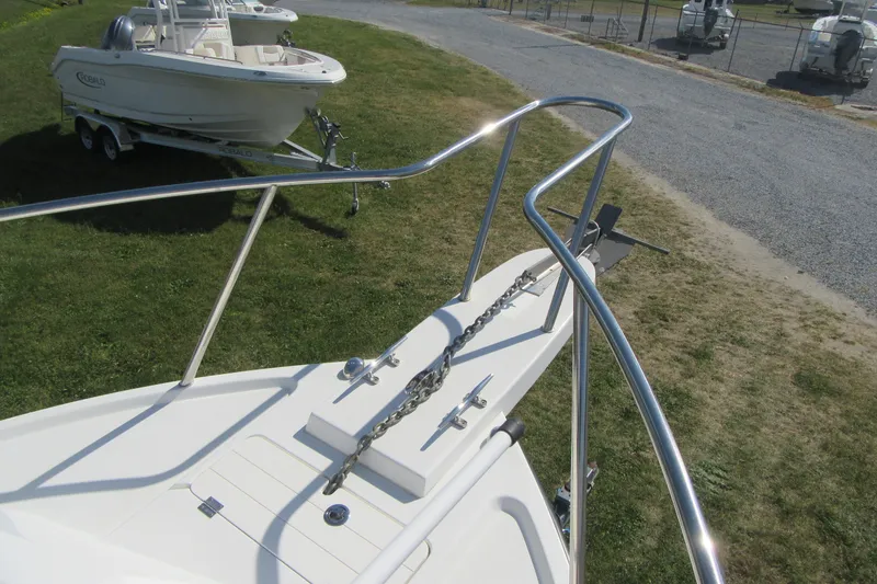 Slide: The Image of 2013 Parker 2320 SL Sport Cabin boat with anchor chain on grassy area. - 27