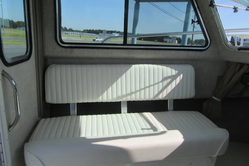 Slide: The Image of Interior of 2013 Parker 2320 SL Sport Cabin with white cushioned seating. - 32