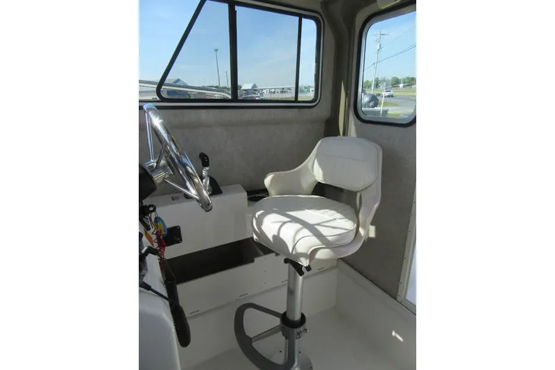 Slide: The Image of Interior of 2013 Parker 2320 SL Sport Cabin with steering wheel and captain's chair. - 34