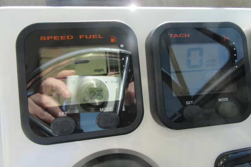 Slide: The Image of Dashboard of a 2013 Parker 2320 SL Sport Cabin showing speed and tachometer gauges. - 39