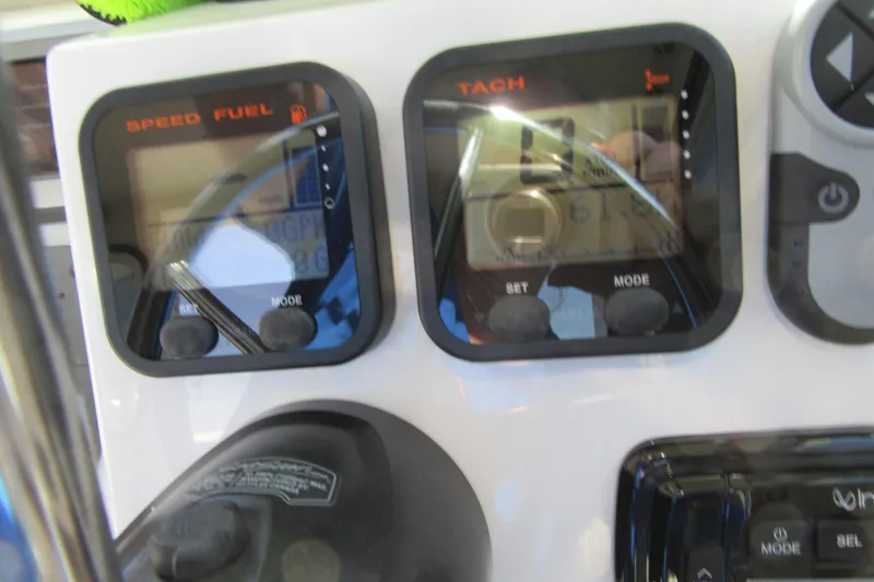 Slide: The Image of Dashboard of a 2013 Parker 2320 SL Sport Cabin boat with speed and tachometer gauges. - 40