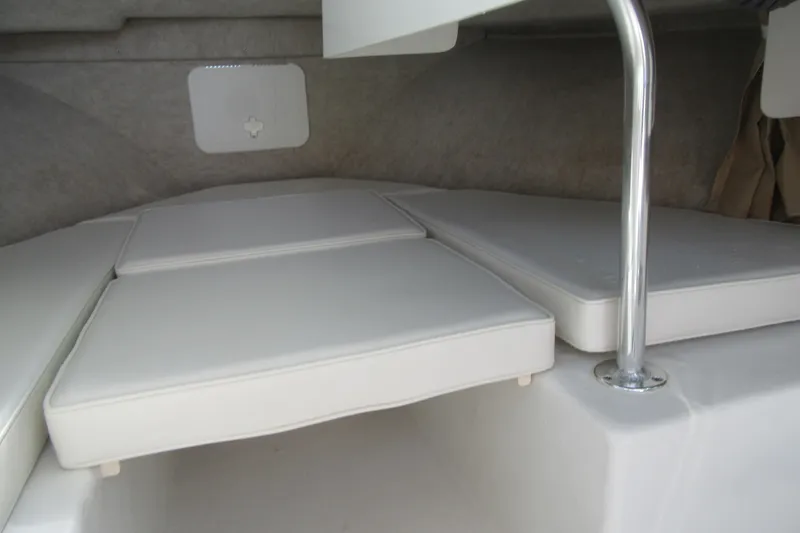 Slide: The Image of Interior cabin view of a 2013 Parker 2320 SL Sport Cabin boat with cushioned seating. - 43
