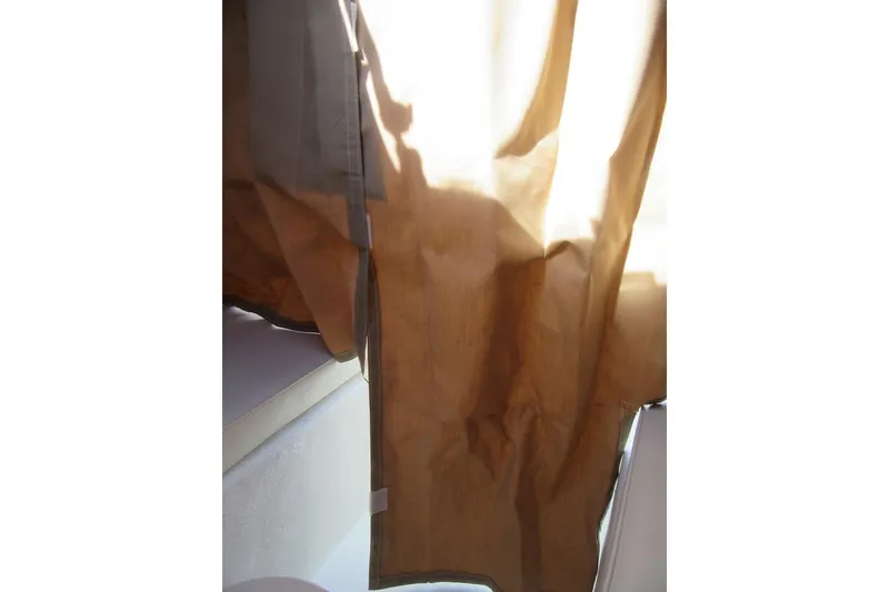 Slide: The Image of Brown curtain inside 2013 Parker 2320 SL Sport Cabin boat, sunlight filtering through. - 50