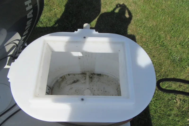 Slide: The Image of Open hatch on 2013 Parker 2320 SL Sport Cabin boat, grassy background. - 9