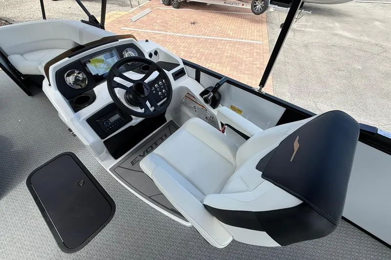 Slide: The Image of Interior of 2026 Evotti 523CS boat, featuring modern steering console and luxurious seating. - 11
