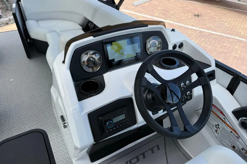 Slide: The Image of 2026 Evotti 523CS boat dashboard with steering wheel and navigation display. - 12