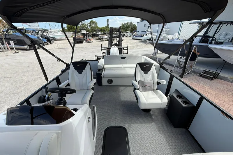 Slide: The Image of Interior of 2026 Evotti 523CS boat with modern seating and steering wheel. - 14