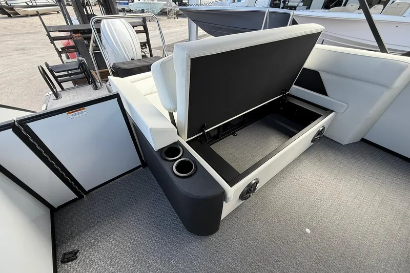 Slide: The Image of Evotti 523CS 2026 boat interior with open storage compartment and cup holders. - 23