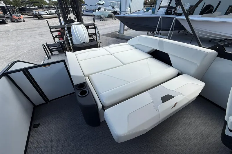 Slide: The Image of Luxurious seating area on 2026 Evotti 523CS boat, featuring white upholstery and cup holders. - 24