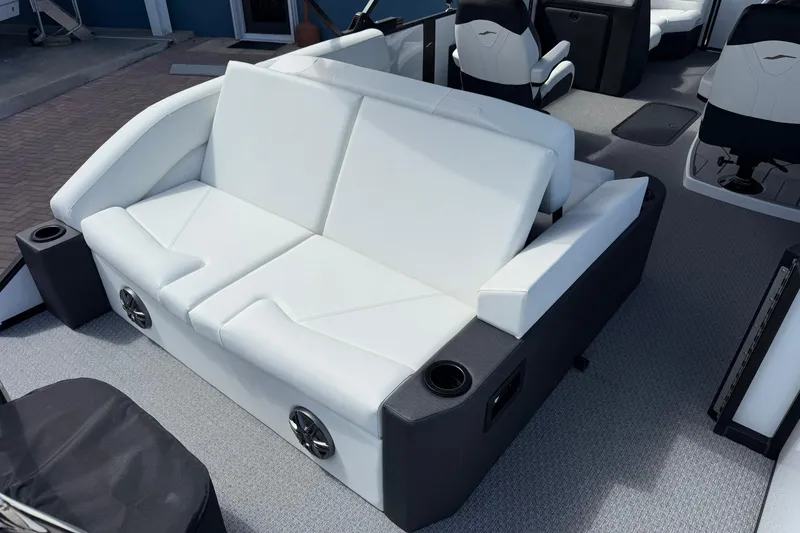 Slide: The Image of Luxurious white seating on 2026 Evotti 523CS boat, featuring integrated speakers and cup holders. - 26