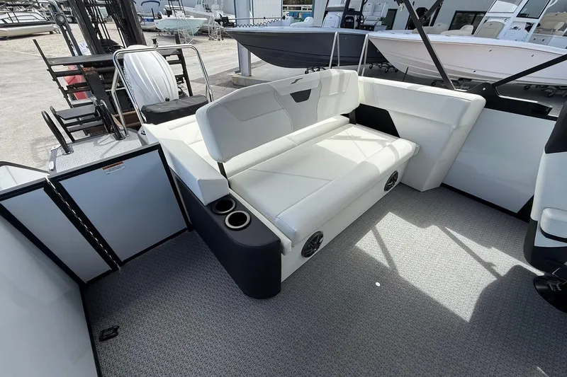 Slide: The Image of 2026 Evotti 523CS boat interior with white seating and cup holders. - 9