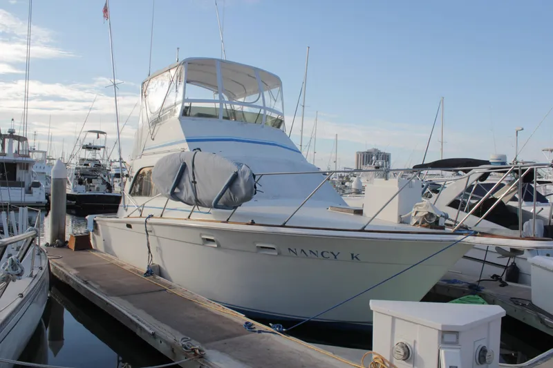Slide: The Image of 1985 Egg Harbor 33 Convertible yacht docked at marina, named "Nancy K". - 1