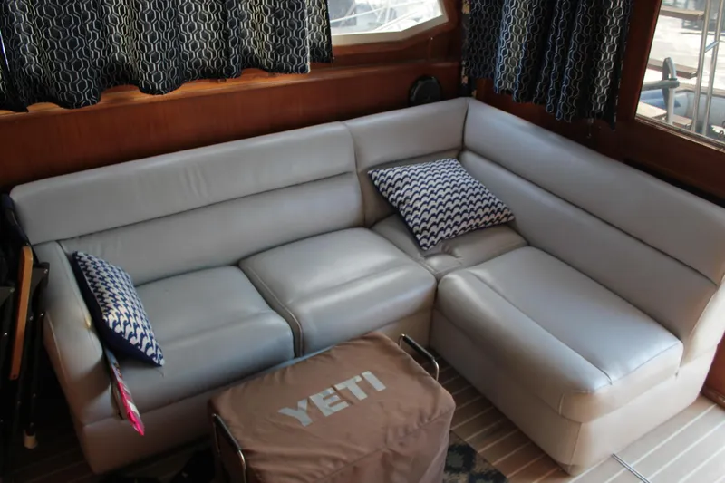 Slide: The Image of Luxurious interior of 1985 Egg Harbor 33 Convertible yacht with plush seating and patterned pillows. - 14