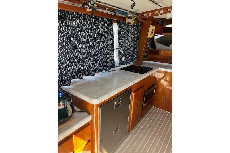 Slide: The Image of Interior of 1985 Egg Harbor 33 Convertible yacht with modern kitchen amenities. - 15