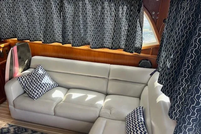 Slide: The Image of Luxurious interior of 1985 Egg Harbor 33 Convertible with white leather sofa and patterned curtains. - 16