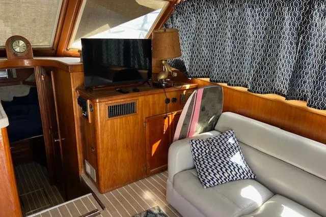 Slide: The Image of Interior of 1985 Egg Harbor 33 Convertible yacht with cozy seating and wooden cabinetry. - 17