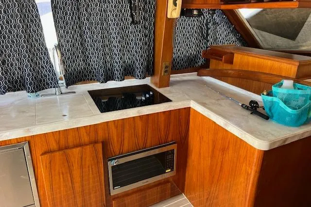 Slide: The Image of Interior of 1985 Egg Harbor 33 Convertible yacht with wooden cabinetry and modern appliances. - 18